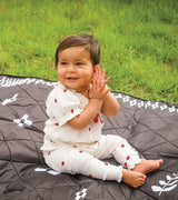 Colugo Playmat used as a picnic blanket in an outdoor setting