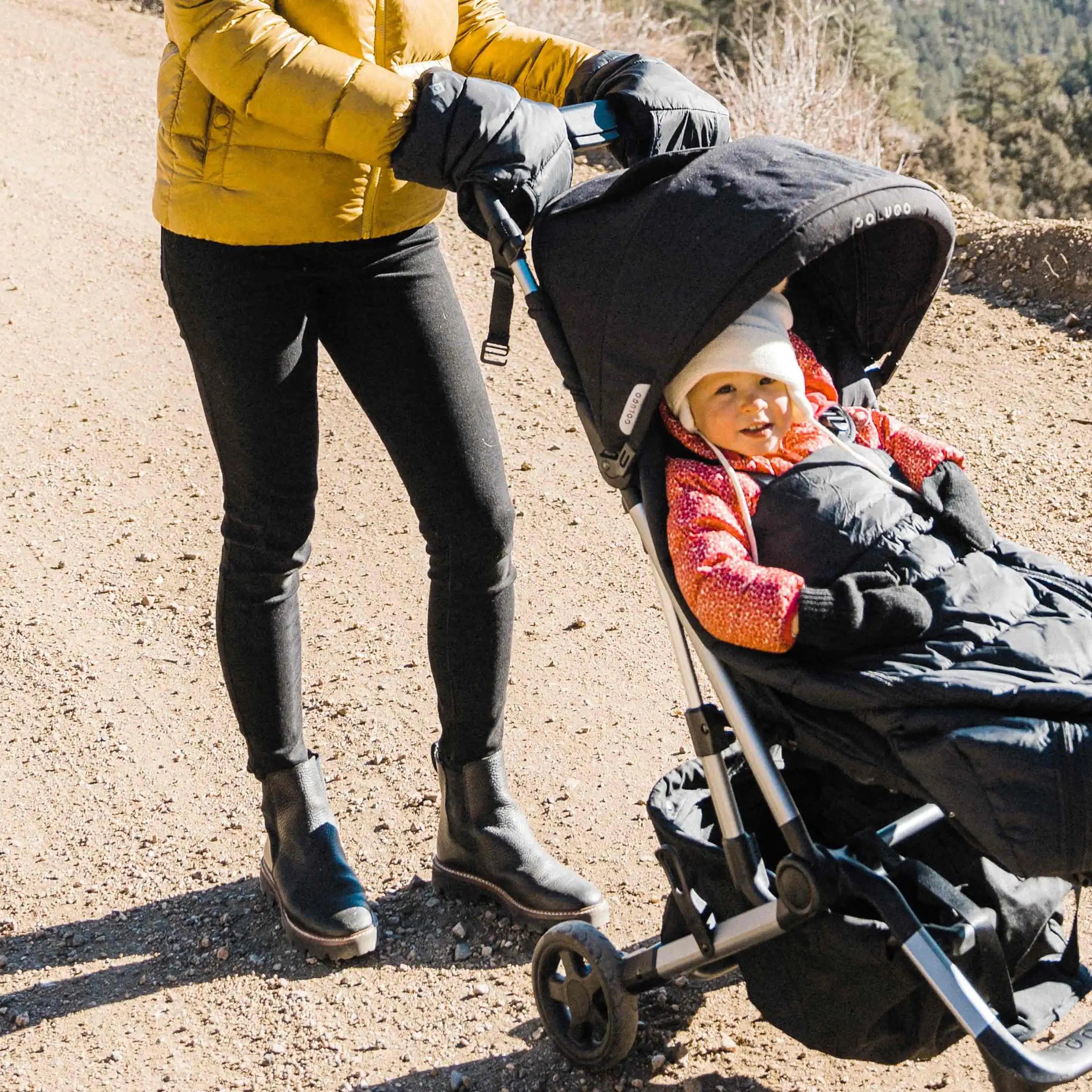 Parent using Black Cozy on stroller
