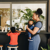 The Baby Carrier, Black in a travel setting