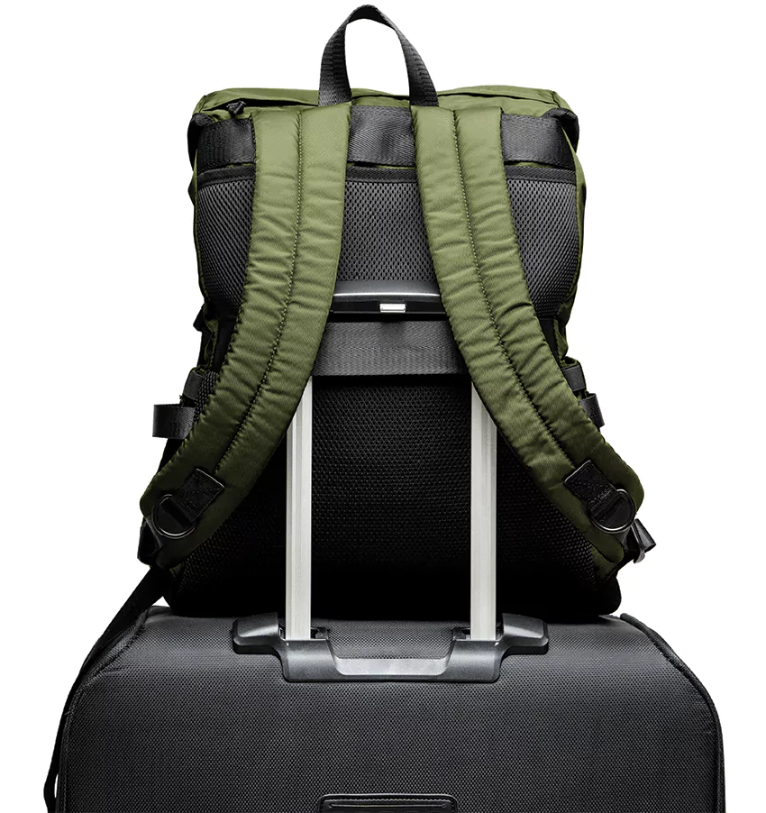 The Parent Backpack, Olive in a travel setting